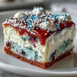 Festive red and blue gelatin swirls within a fluffy Patriotic Poke Cake.