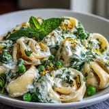 Close-up of lemon ricotta pasta with peas and mint, ready to be served.