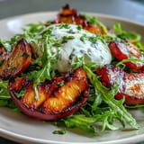 Grilled Peach and Burrata Salad with honey, showing creamy cheese and caramelized fruit.