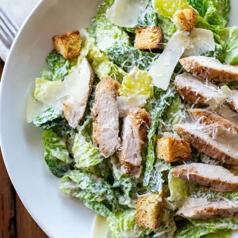 Freshly made, vibrant Chicken Caesar Salad, a satisfying lunch or dinner option.