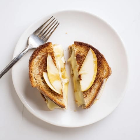 Smoked Gouda & Apple Grilled Cheese is a comforting lunch option, featuring gooey cheese and tart apples on buttery bread.
