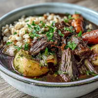 Rich One-Pot Guinness Beef and Barley Stew with tender chunks of beef, root vegetables, and hearty barley in a deep, savory broth—perfect for cozy dinners.