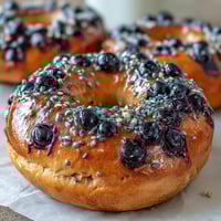 Homemade blueberry protein bagels topped with a zesty lemon glaze, perfect for a healthy and energizing breakfast.  