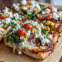 Vibrant St. Patrick's Day Rainbow Veggie Flatbread Pizza with fresh, colorful vegetables arranged in festive stripes.  