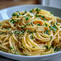 Creamy lemon butter pasta with fresh lemon zest, garlic, and Parmesan in a silky sauce, perfect for a quick vegetarian dinner.