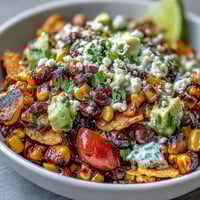 Vibrant grilled corn and black bean taco salad piled high with fresh, crisp ingredients.